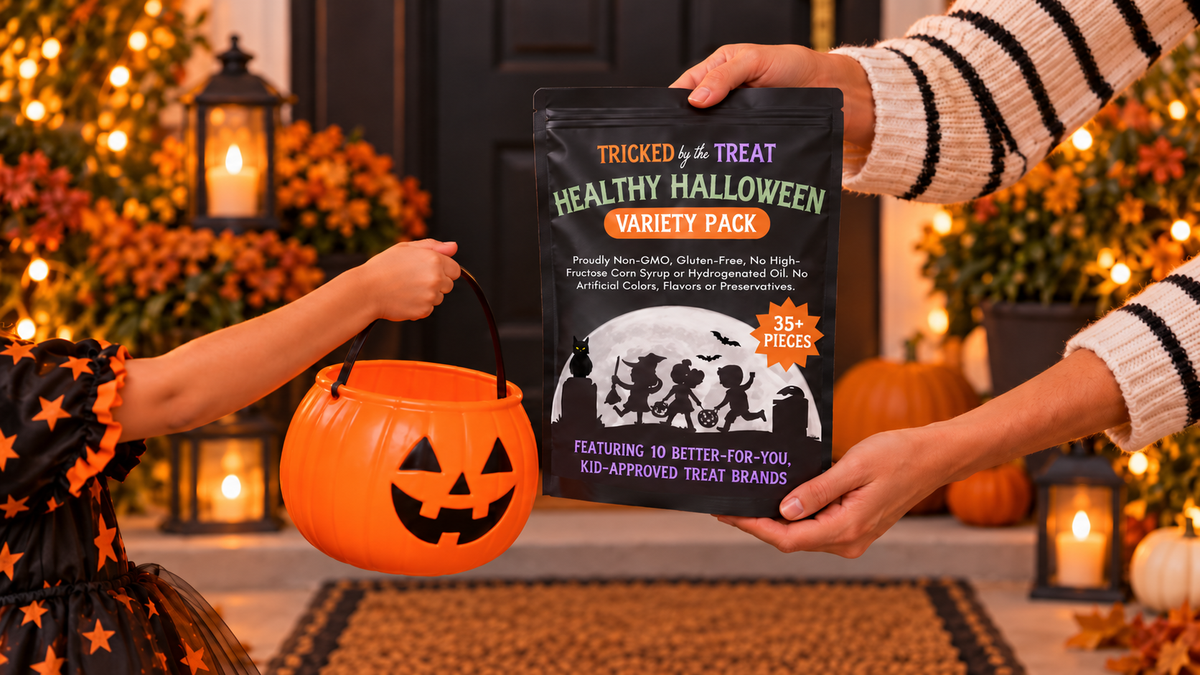 An adult offering a Tricked by the Treat Variety Pack to a child holding a pumpkin candy bucket